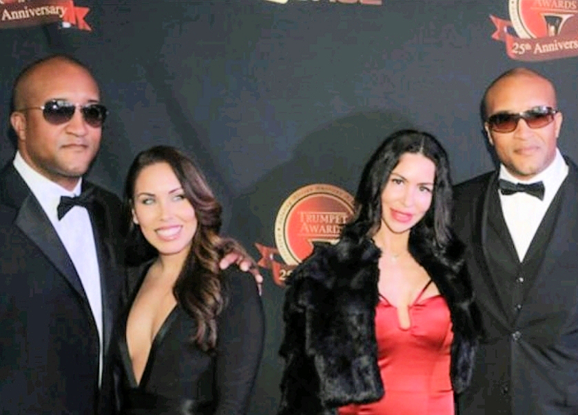 Vince and Vance Moss, the Moss Twins, walking the red carpet with their wives Donna and Leslie.