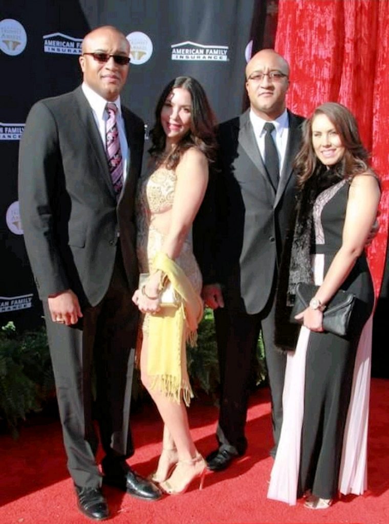 Vince and Vance Moss, the Moss Twins, walking the red carpet with their wives Donna and Leslie.